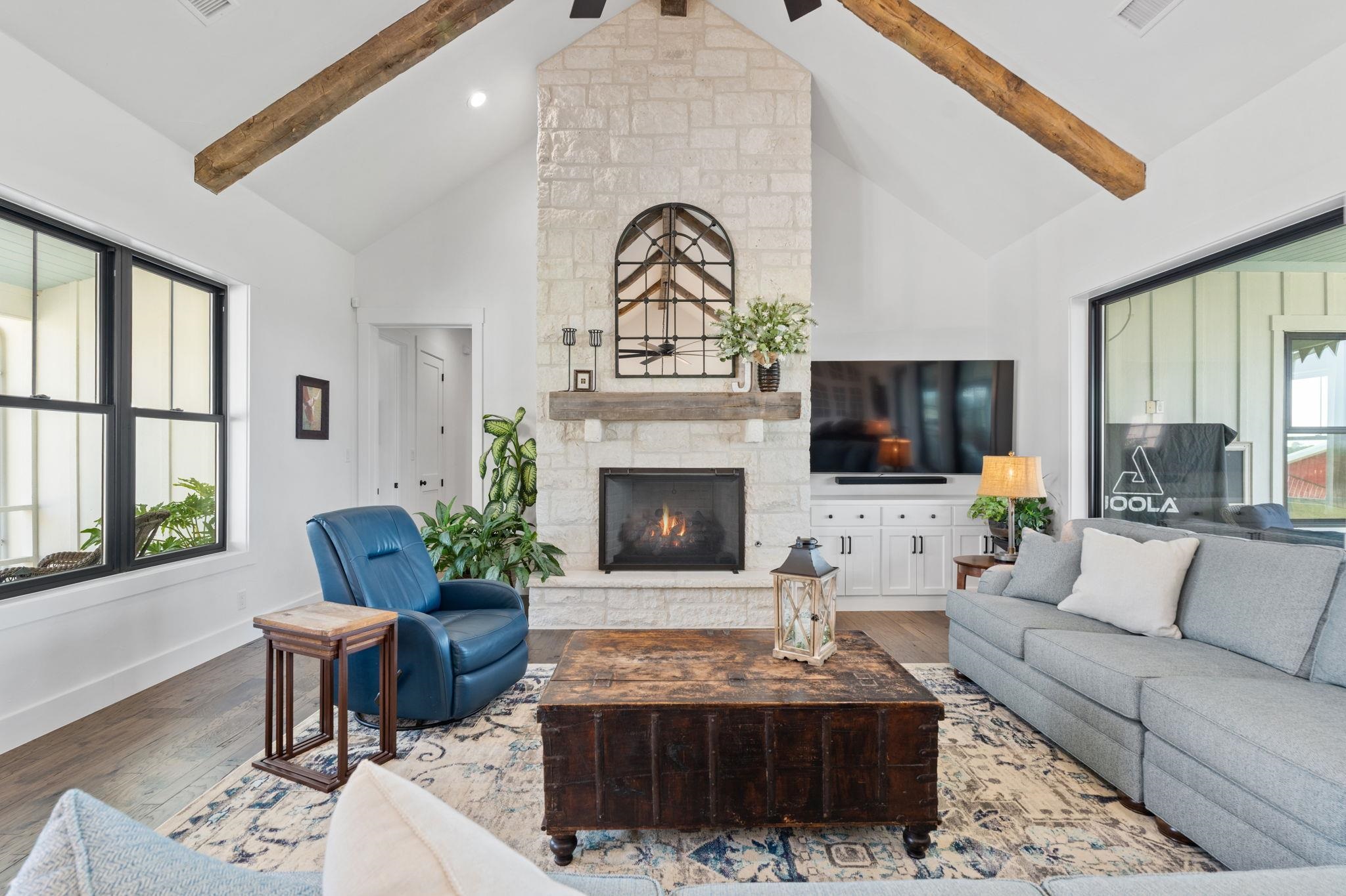 452 Southwick Ranch Road Johnson City, TX 78636 - Photo 4 of 30 a living room with furniture a fireplace and a flat screen tv