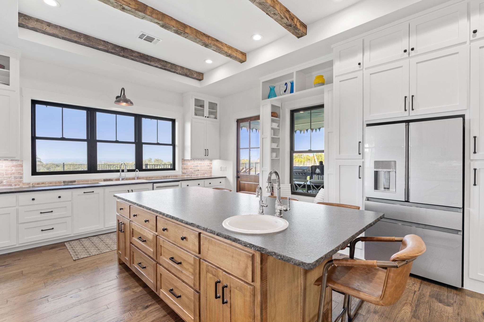452 Southwick Ranch Road Johnson City, TX 78636 - Photo 7 of 30 a kitchen with granite countertop a sink cabinets and wooden floor