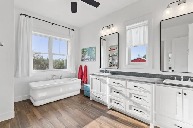 a spacious bedroom with a bed and a dresser