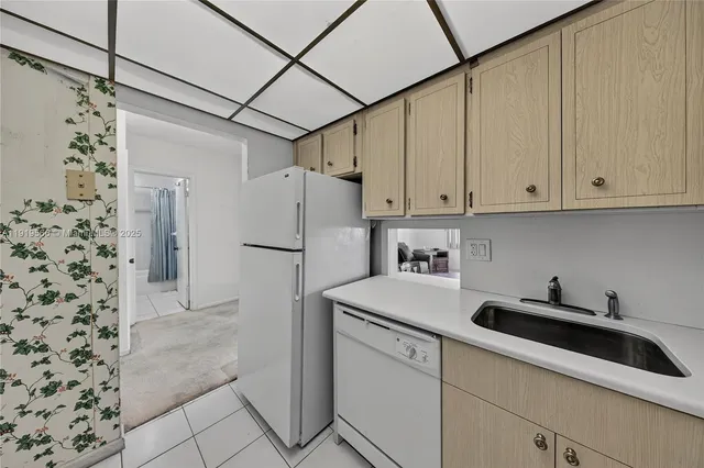 a kitchen with a refrigerator and cabinets