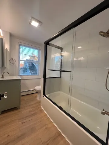 a bathroom with a bathtub and a shower