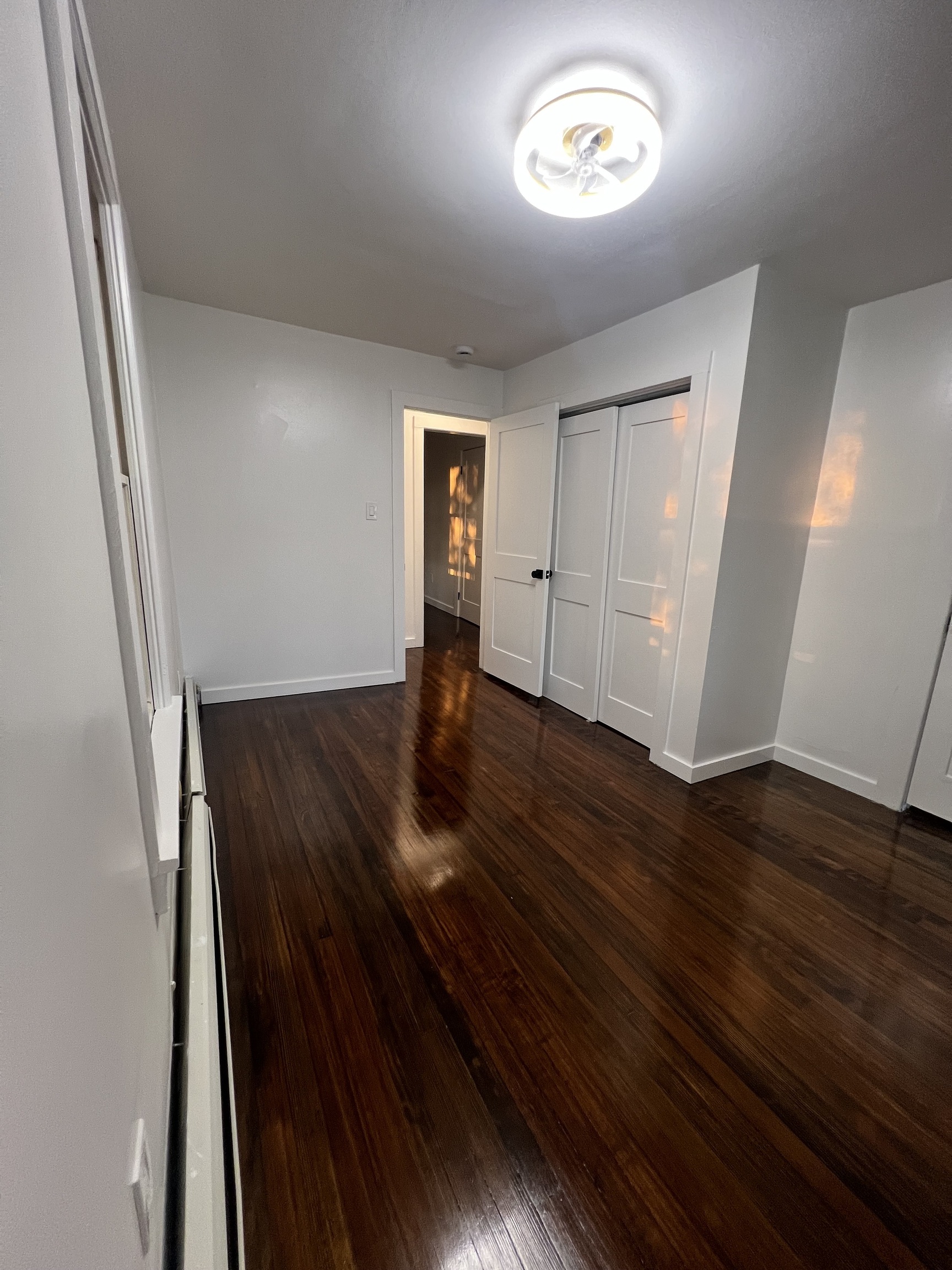 7 Longview Court Norwalk, CT 06851 - Photo 7 of 9 an empty room with wooden floor and a window