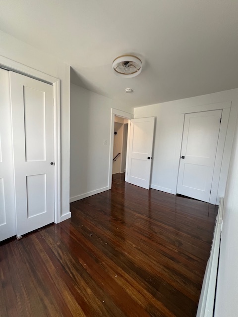7 Longview Court Norwalk, CT 06851 - Photo 8 of 9 an empty room with wooden floor and cabinet