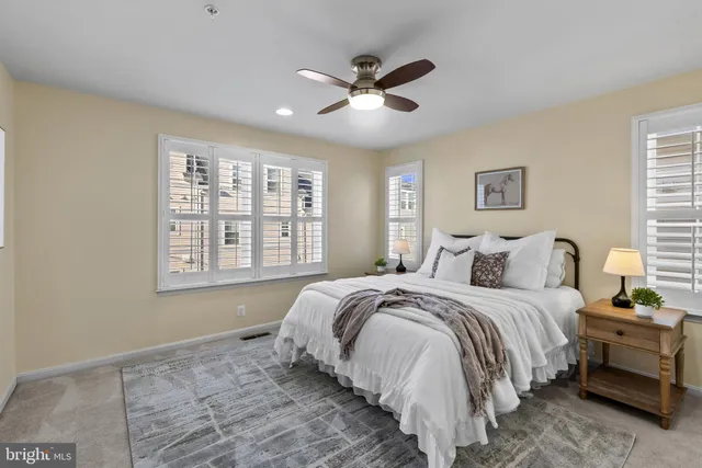 a bathroom with a granite countertop sink a mirror and shower