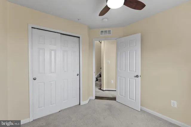 a view of a hallway with wooden floor and windows
