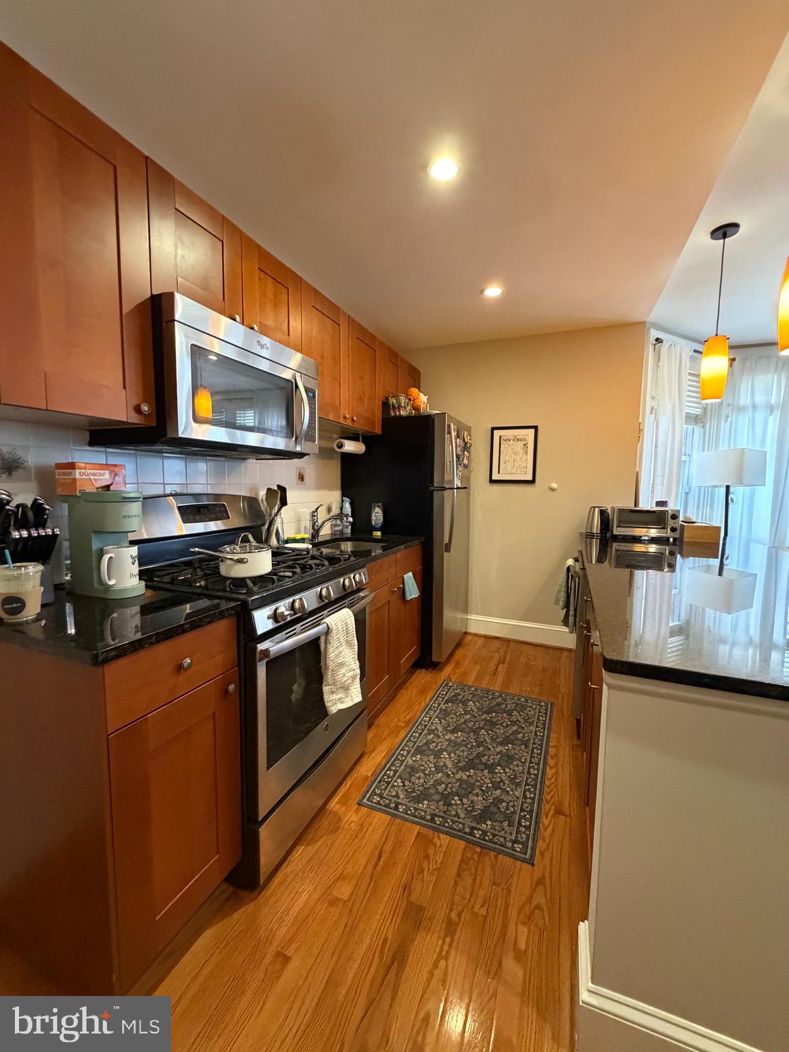 1820 Pine Street, Unit 1R Philadelphia, PA 19103 - Photo 4 of 17 a kitchen with stainless steel appliances granite countertop a sink stove and refrigerator