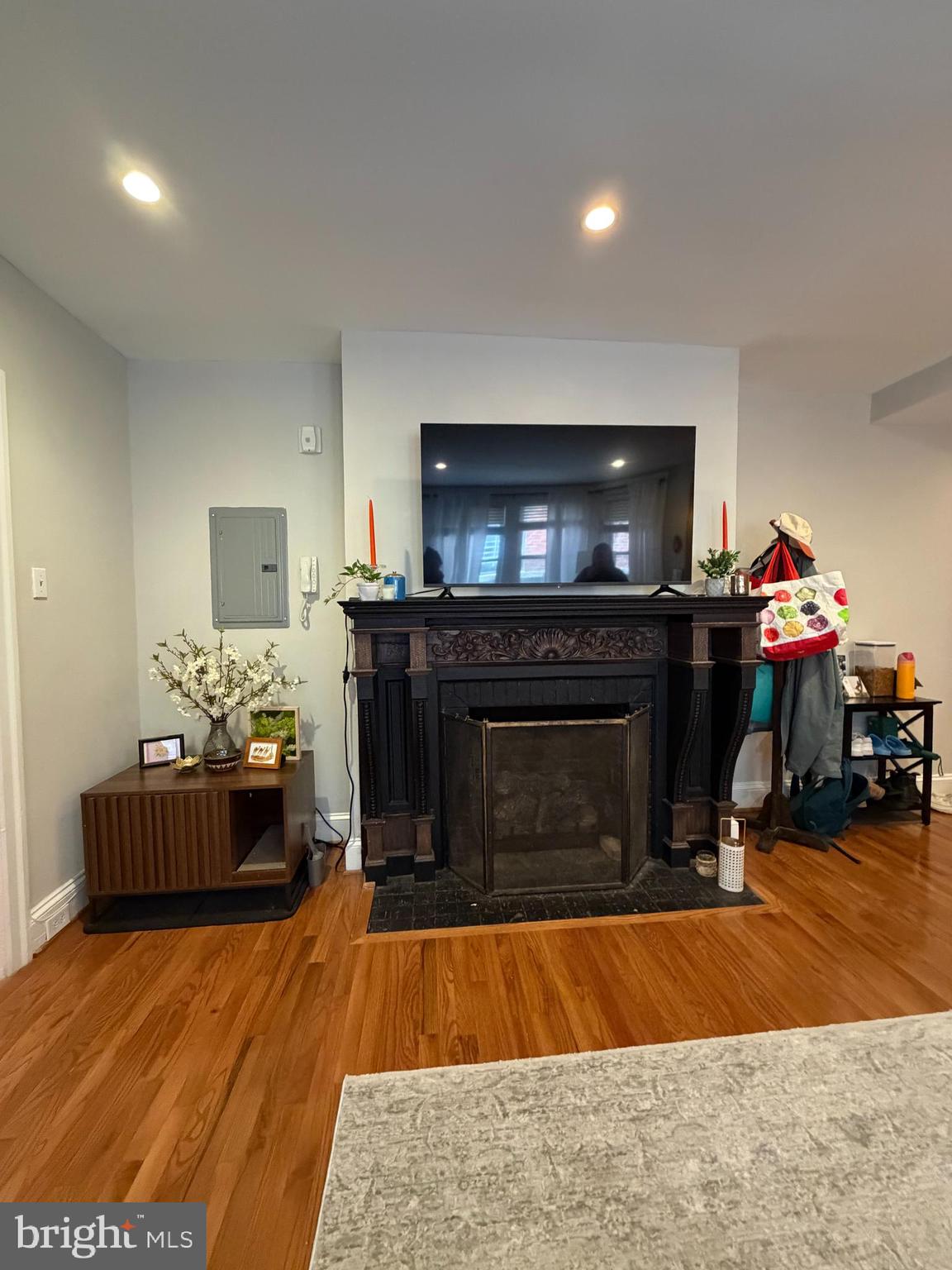 1820 Pine Street, Unit 1R Philadelphia, PA 19103 - Photo 7 of 17 a living room with furniture a flat screen tv and a fireplace