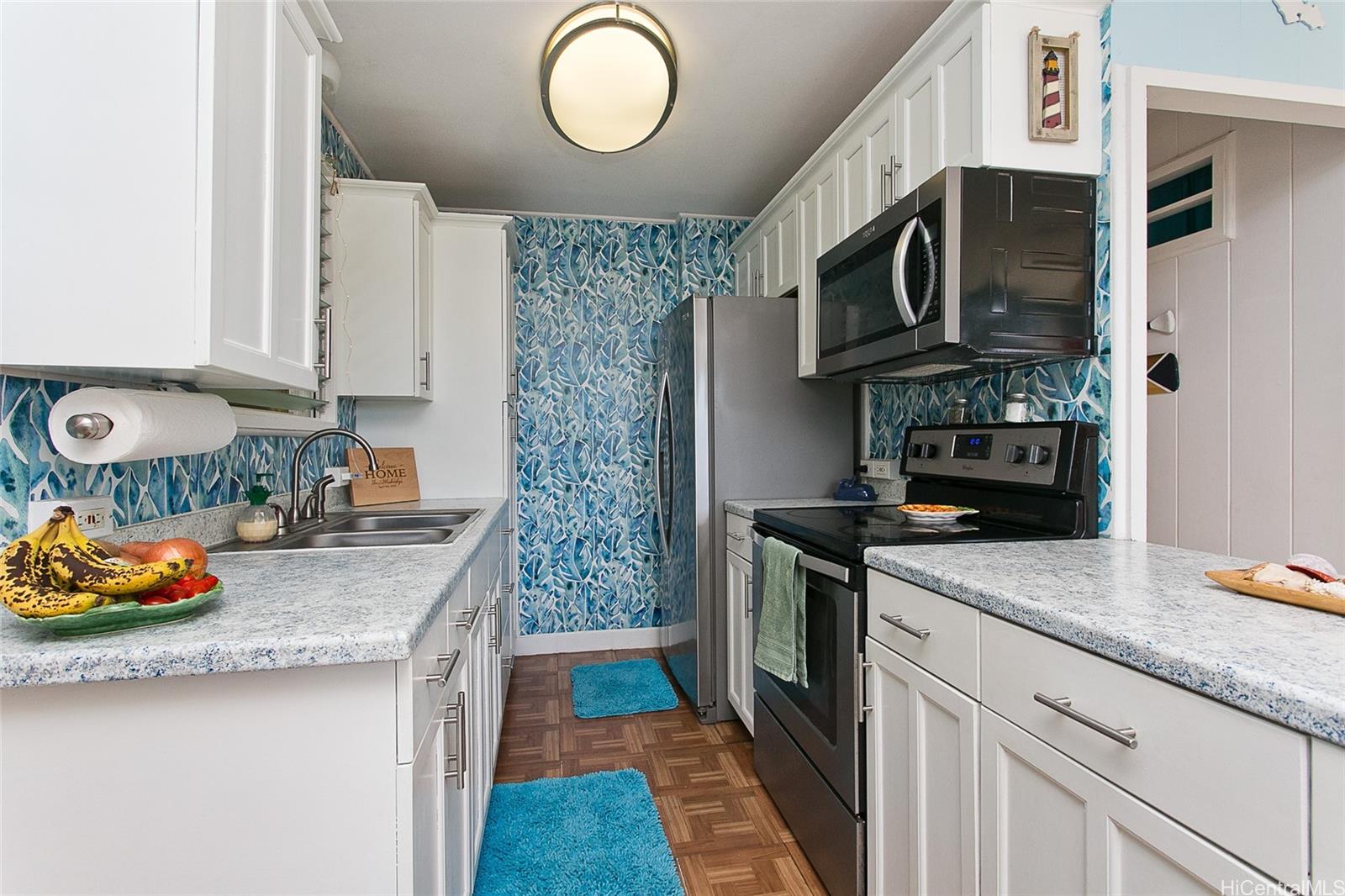 45-557 Keaahala Road, Unit J Kaneohe, HI 96744 - Photo 1 of 1 a kitchen with stainless steel appliances granite countertop a stove and a sink