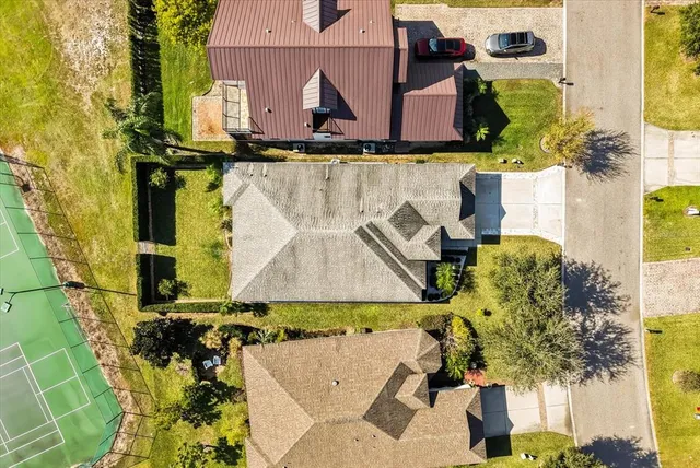 aerial view of a house with a yard and sitting area