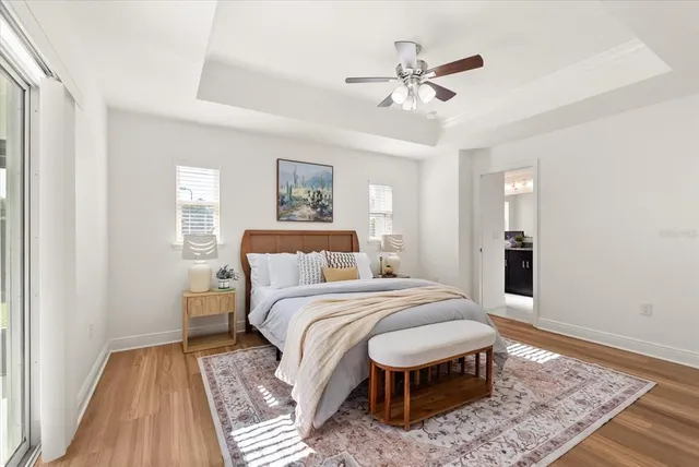 a bedroom with a large bed and a chandelier