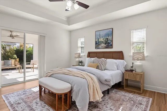 a spacious bedroom with a bed a lamp and large window