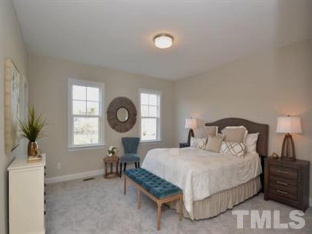 126 Philip's Square Chapel Hill, NC 27516 - Photo 12 of 25 a bedroom with a bed table chair and window