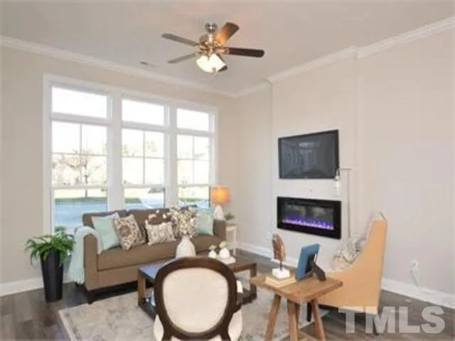 a kitchen with stainless steel appliances granite countertop a stove top oven a sink a dining table and chairs with wooden floor