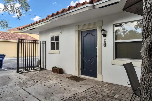 a view of a porch with a floor to ceiling window and wooden floor