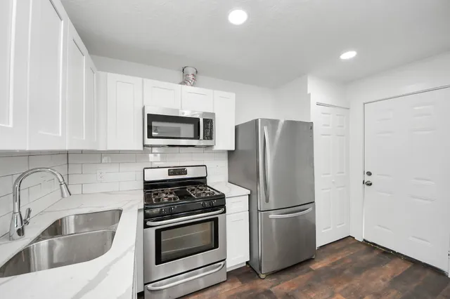 a kitchen with a refrigerator sink and microwave
