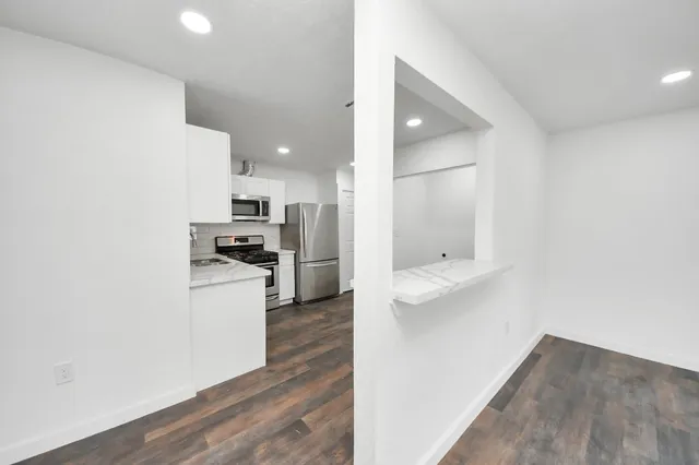 a view of kitchen with wooden floor