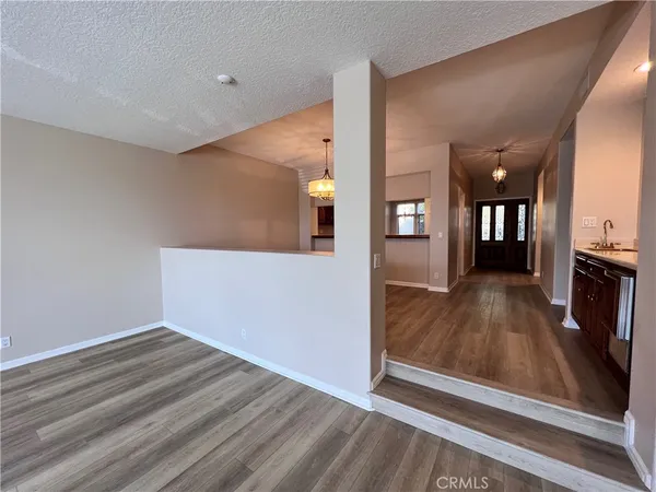 a view of a living room with wooden floor