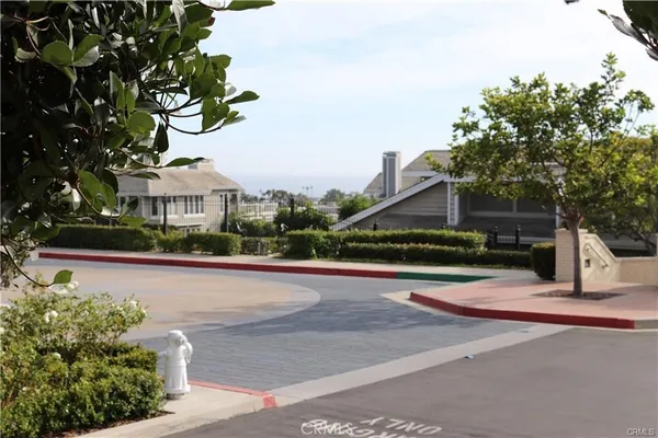 a view of street with houses and wooden fence