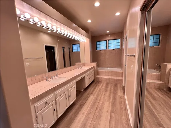 a spacious bathroom with a double vanity sink and a mirror