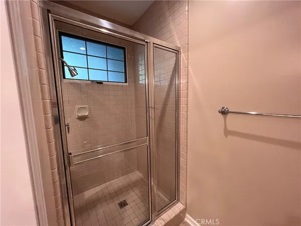 a bathroom with a glass shower door