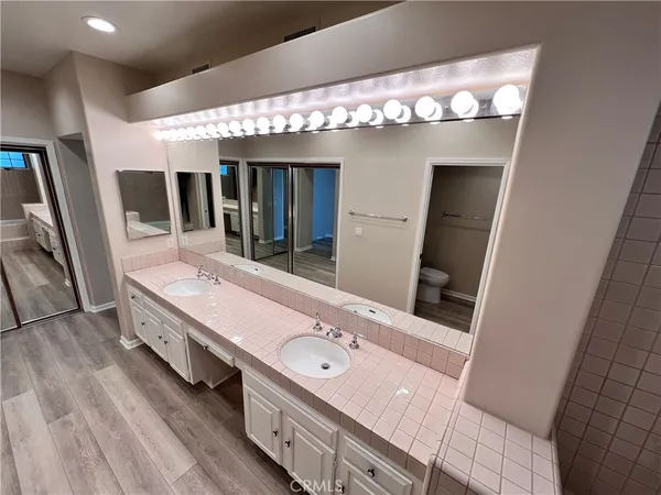 a bathroom with a sink a large mirror and a shower
