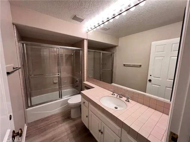 a bathroom with a double vanity sink toilet and shower