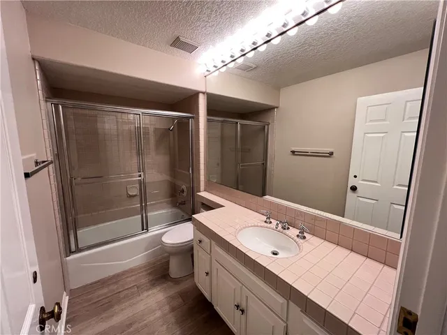 a bathroom with a double vanity sink toilet and shower