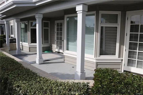 a view of house with backyard and glass windows