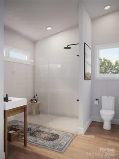 a bathroom with a toilet and a shower