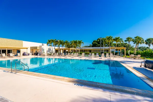 a view of a swimming pool with an outdoor seating and a yard