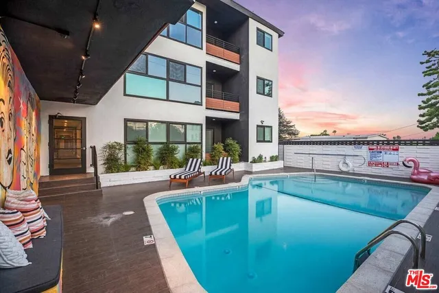 a view of a patio with swimming pool table and chairs