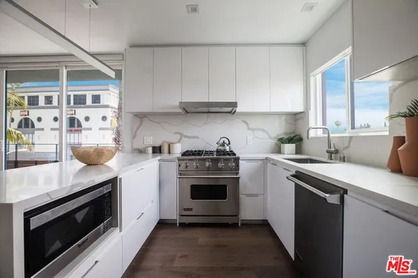 a kitchen with stainless steel appliances granite countertop a stove and a sink