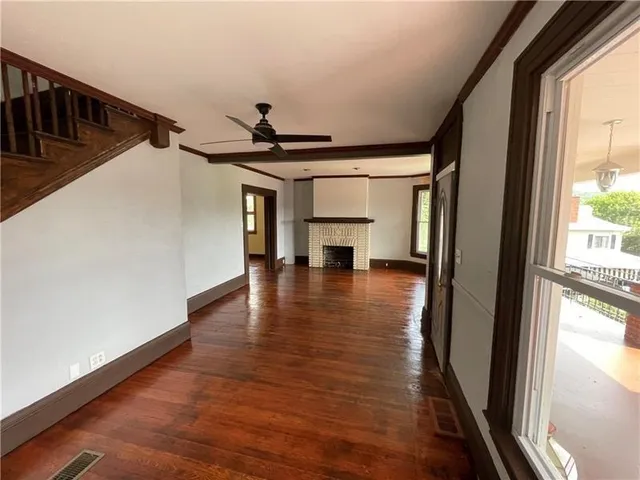a view of a hallway view with wooden floor and staircase