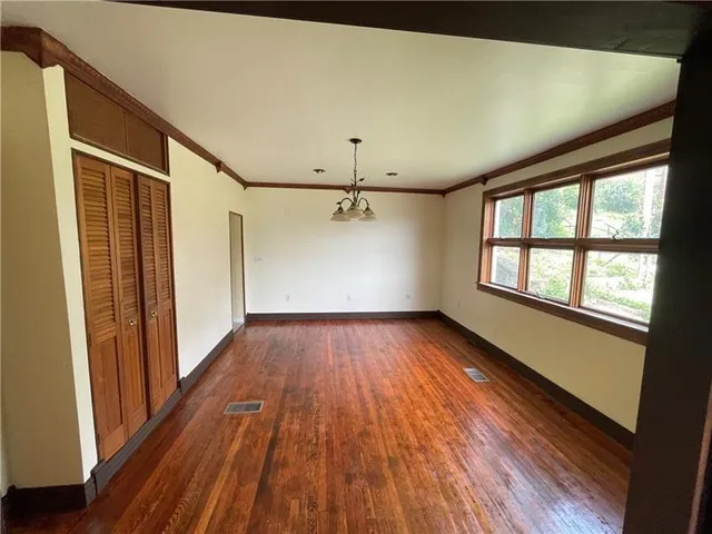 wooden floor in an empty room with a window