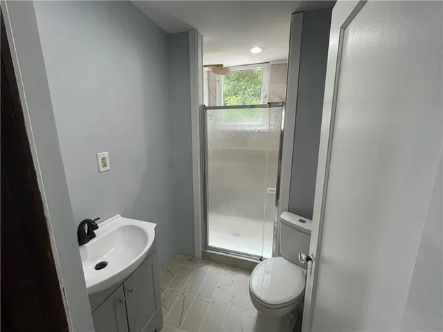 a bathroom with a sink toilet and shower