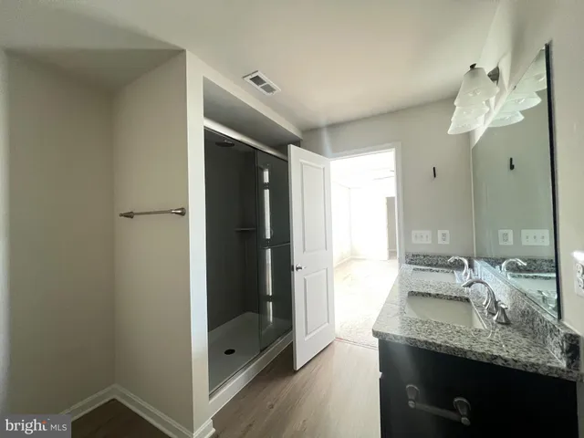 a bathroom with a double vanity sink and mirror