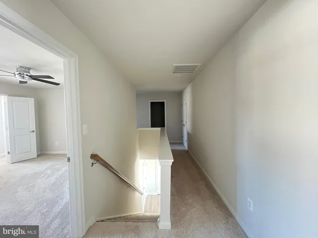 a view of a livingroom with a ceiling fan and window