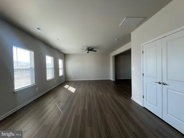 a view of a kitchen with furniture and wooden floor
