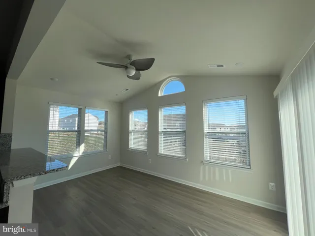 a kitchen with stainless steel appliances granite countertop a sink dishwasher a refrigerator and a oven with wooden floors