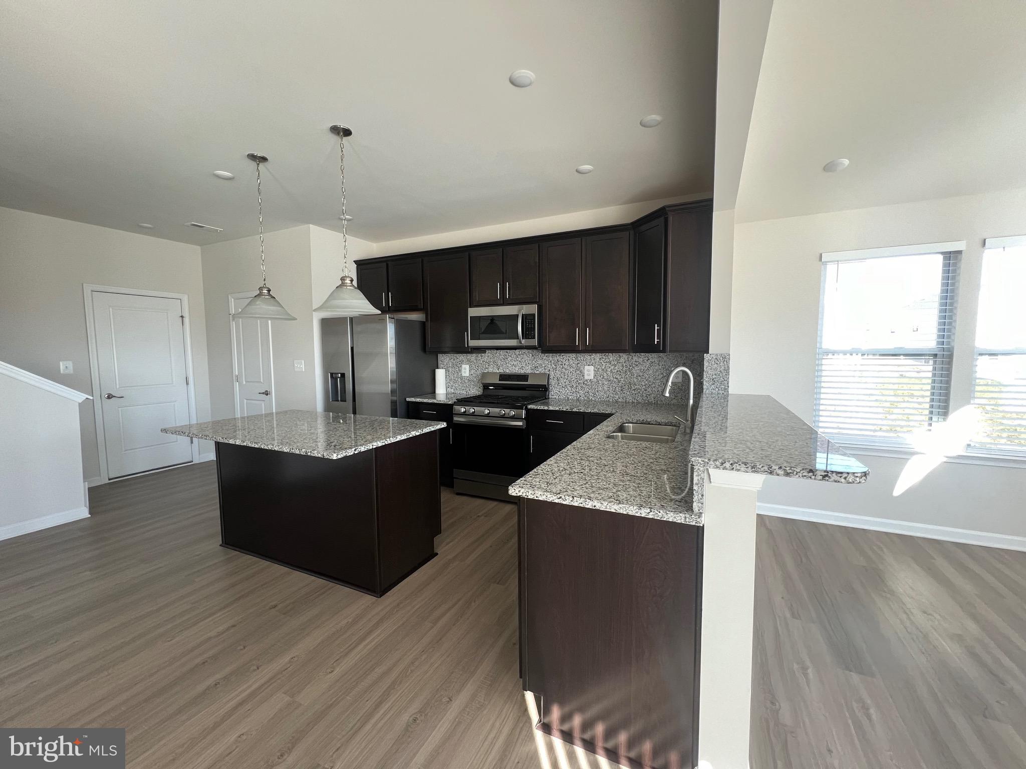 35 Signal Knob Cottage Drive Strasburg, VA 22657 - Photo 26 of 30 a kitchen with stainless steel appliances granite countertop a sink dishwasher a refrigerator and a oven with wooden floors