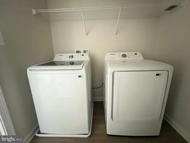 a kitchen with granite countertop a refrigerator stove and microwave