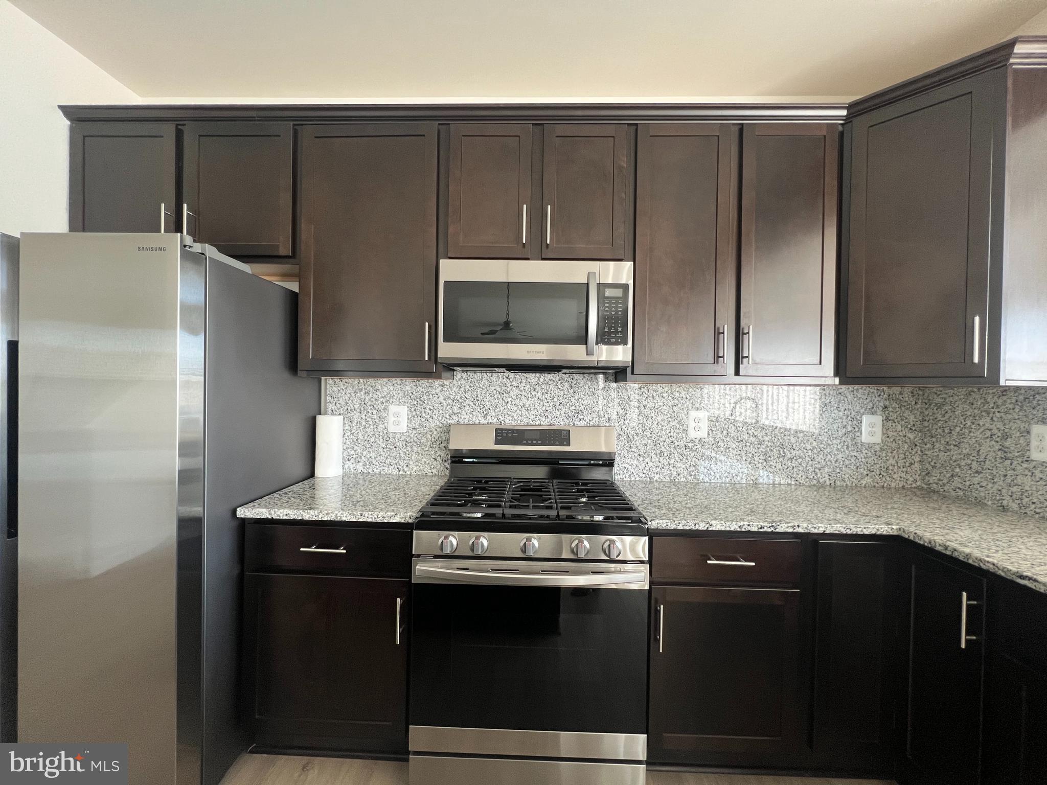 35 Signal Knob Cottage Drive Strasburg, VA 22657 - Photo 29 of 30 a kitchen with granite countertop a refrigerator stove and microwave