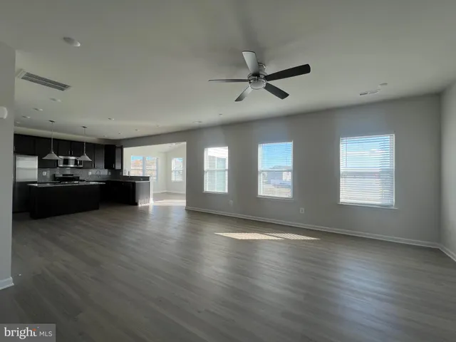 a view of a livingroom with furniture hardwood floor and staircase