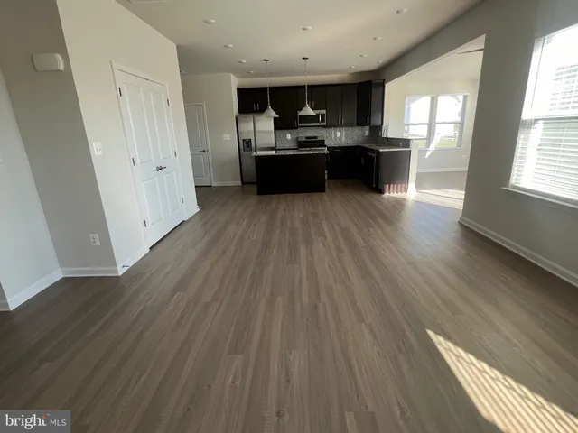 a view of kitchen with sink microwave refrigerator and stove