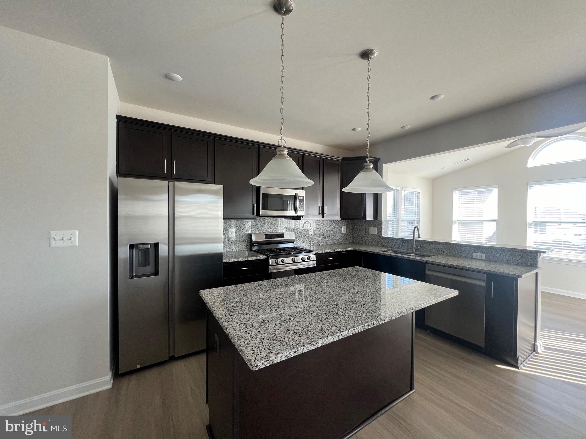 35 Signal Knob Cottage Drive Strasburg, VA 22657 - Photo 7 of 30 a kitchen with stainless steel appliances granite countertop a sink a stove a refrigerator and island