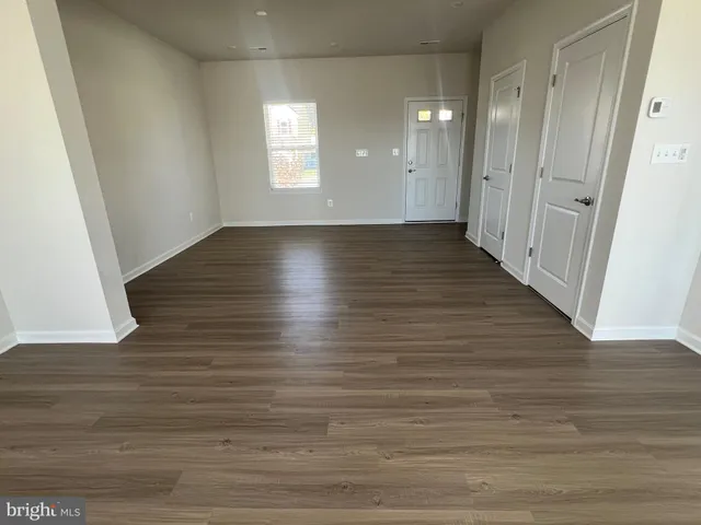 a view of room with window and wooden floor