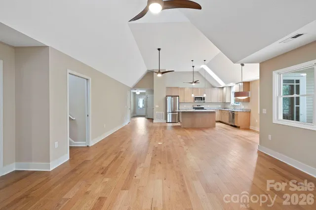 a view of a kitchen with furniture and wooden floor