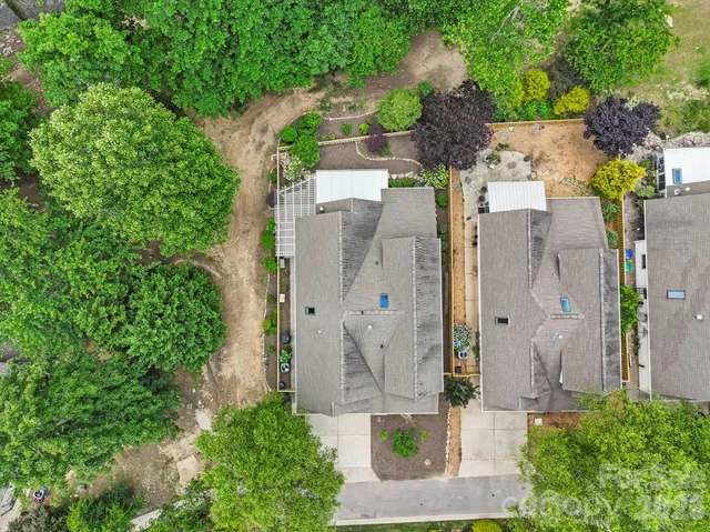 an aerial view of a house with outdoor space and parking