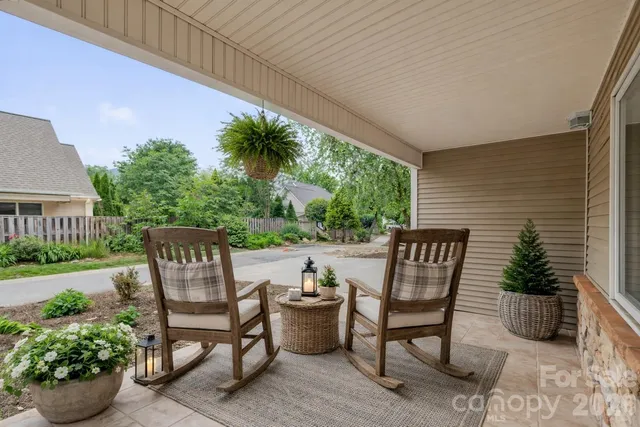a view of patio with a table and chairs and potted plants