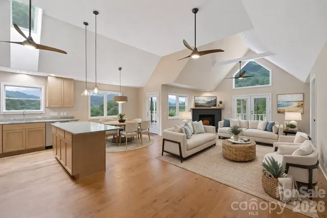 a living room with furniture a fireplace and a chandelier
